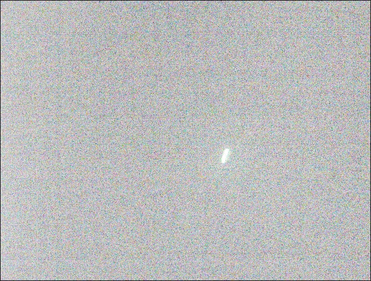 a grainy image showing a bright blurry shape