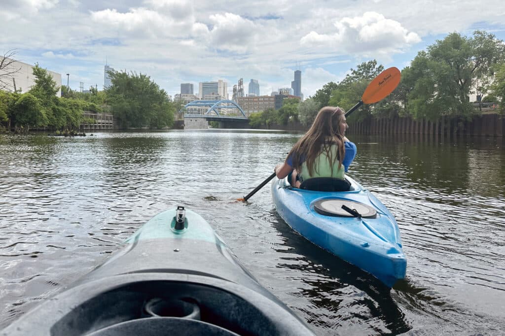 Krystyna Kurth paddles toward downtown on the Chicago River. Credit: Leigh Giangreco/Inside Climate News