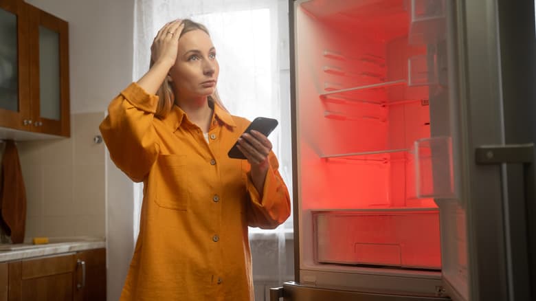 A woman in distress over a malfunctioning fridge.