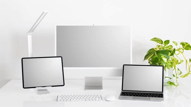 iPad on desktop with computer and peripherals